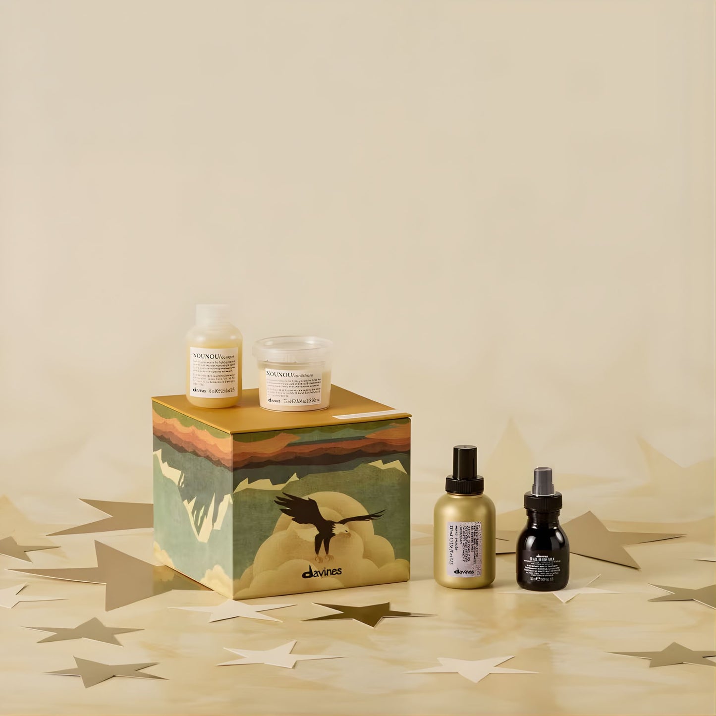 Cosmetic products including bottles and a box on a beige background