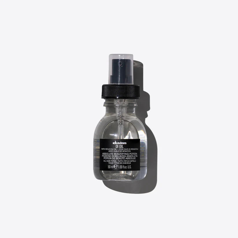 Davines OI Oil 50ml — lightweight finishing oil infused with Roucou oil, designed to add shine, smooth frizz, and protect all hair types for a silky, radiant finish.