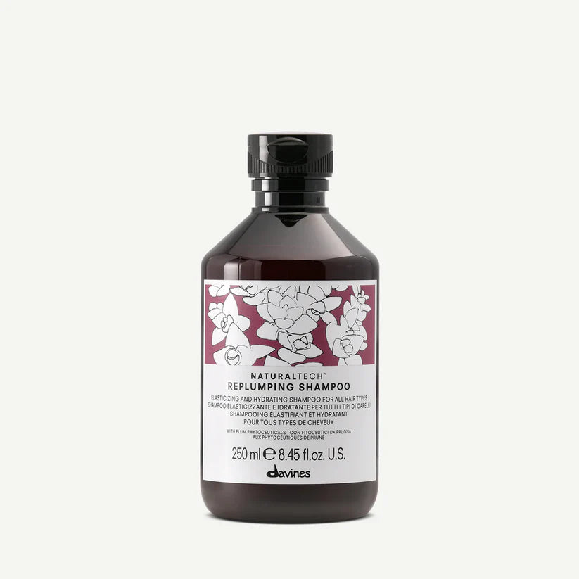 Davines Naturaltech Replumping Shampoo — hydrating and elasticity-boosting shampoo enriched with plum phytoceuticals and hyaluronic acid, designed to plump, strengthen, and add shine to fine or dehydrated hair.