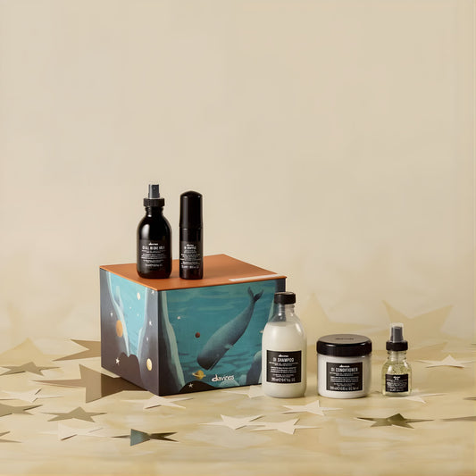 Collection of Davines hair care products on a beige background