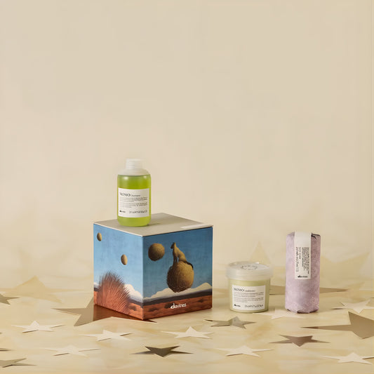 Cosmetic products including a bottle, jar, and box on a beige surface with a minimal background