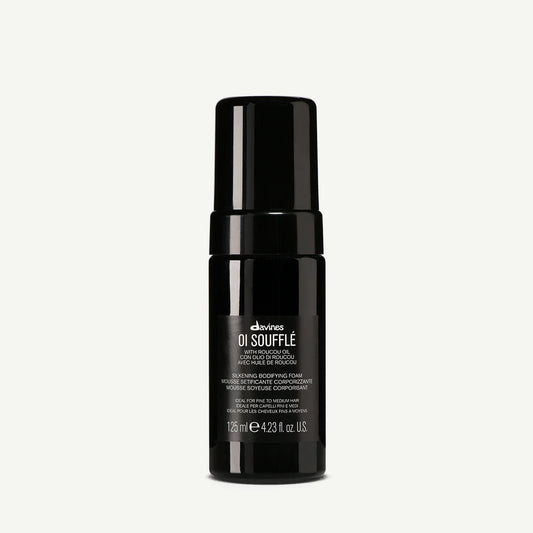 Davines OI Soufflé leave-in mousse 125ml. A liquid-to-foam formula with Roucou oil that adds body, shine, and heat protection for fine to medium hair.