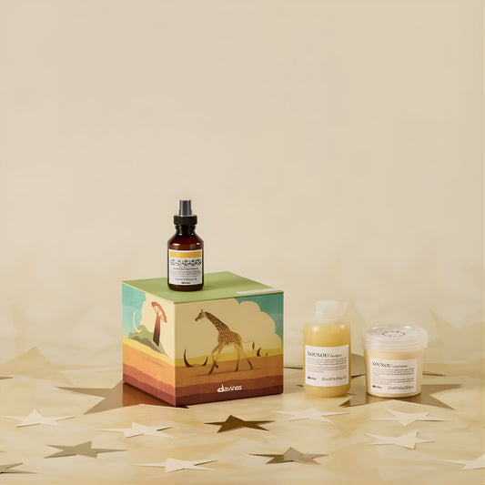 Davines hair care products on a decorative box with a giraffe design on a beige background