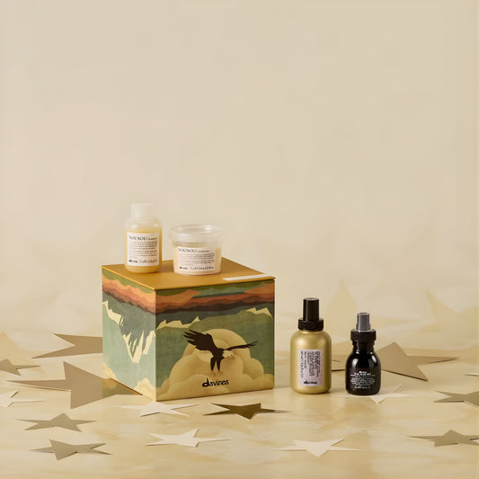 Cosmetic products including bottles and a box on a beige background
