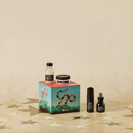Set of haircare products on a decorative box with a beige background