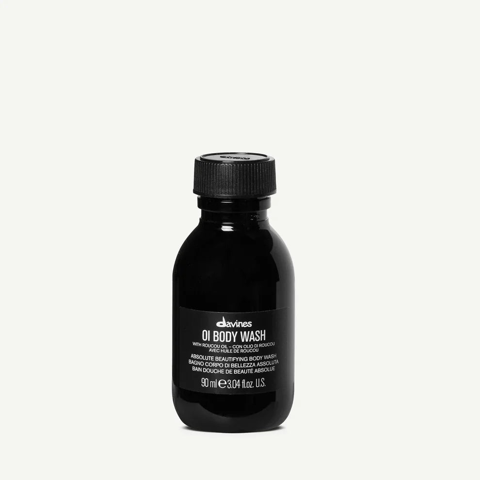 Black bottle of Davines OI Body Wash on a white background