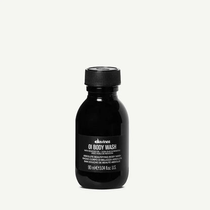 Black bottle of Davines OI Body Wash on a white background